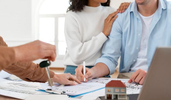 smiley-couple-signing-contract-new-house